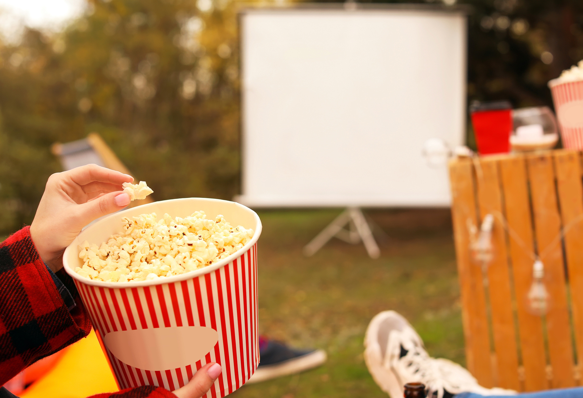 Woman with Popcorn Watching a Movie in Outdoor Cinema